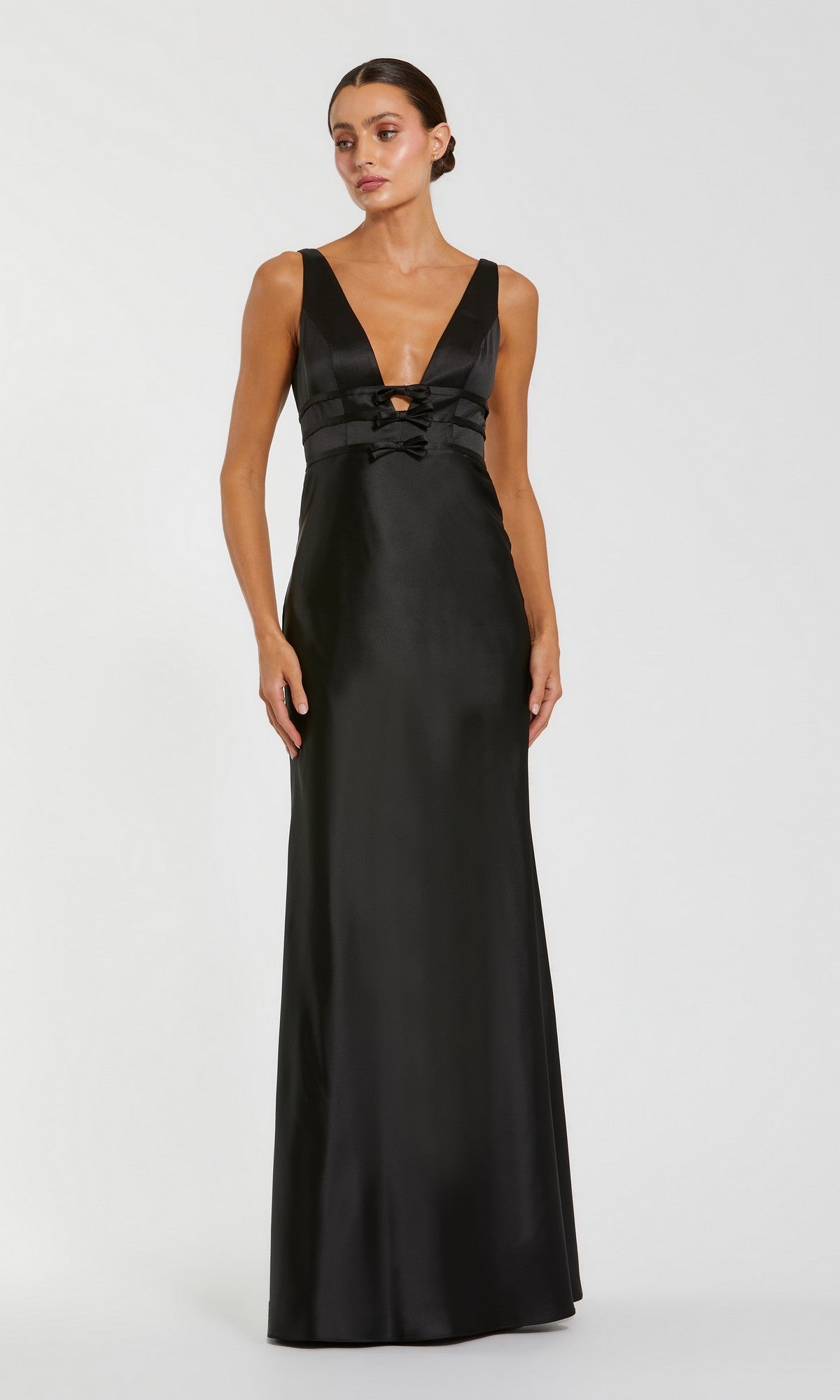 Woman in the Raspberry Long Satin Prom Dress (Mac Duggal 68855), a sleek sleeveless gown with deep V-neckline and fitted bodice, posing elegantly against a plain light background.
